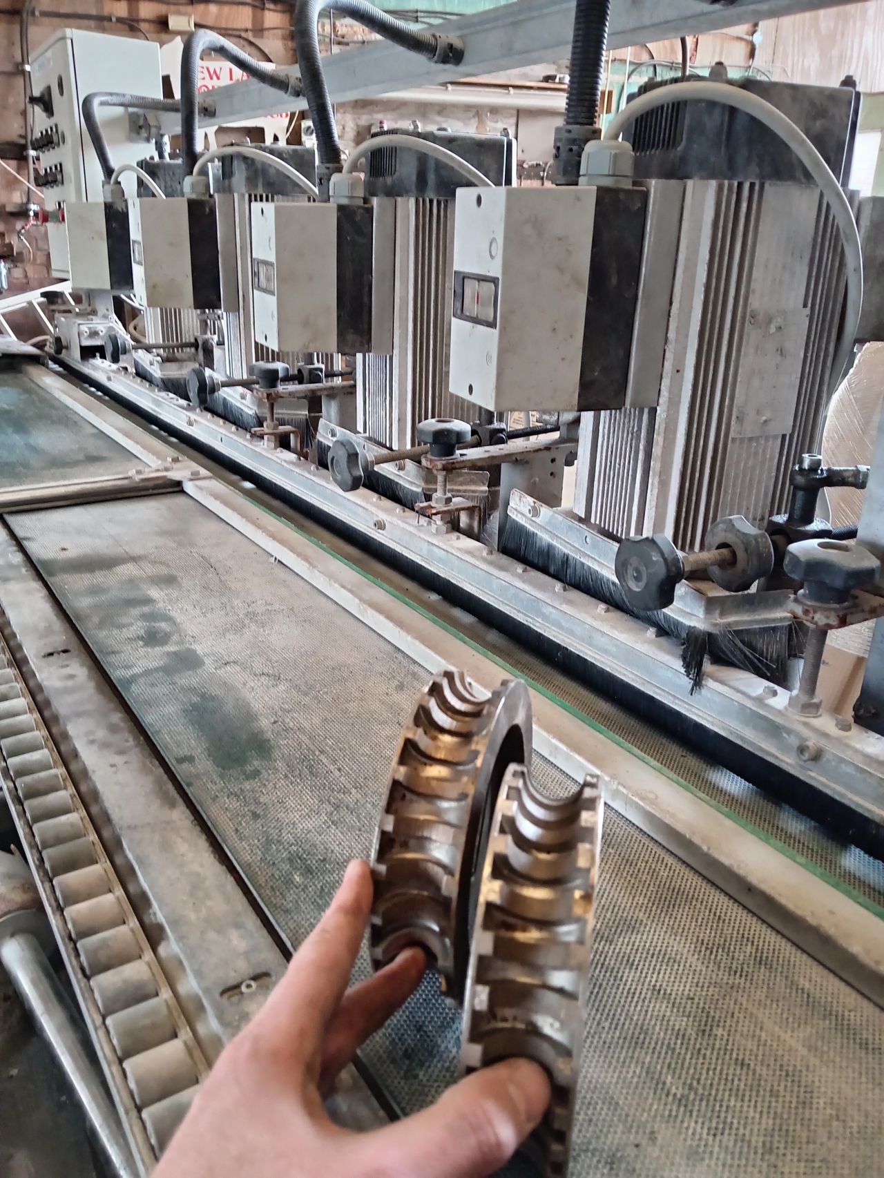 Close-up of the profiling wheel on the bullnose machine in use