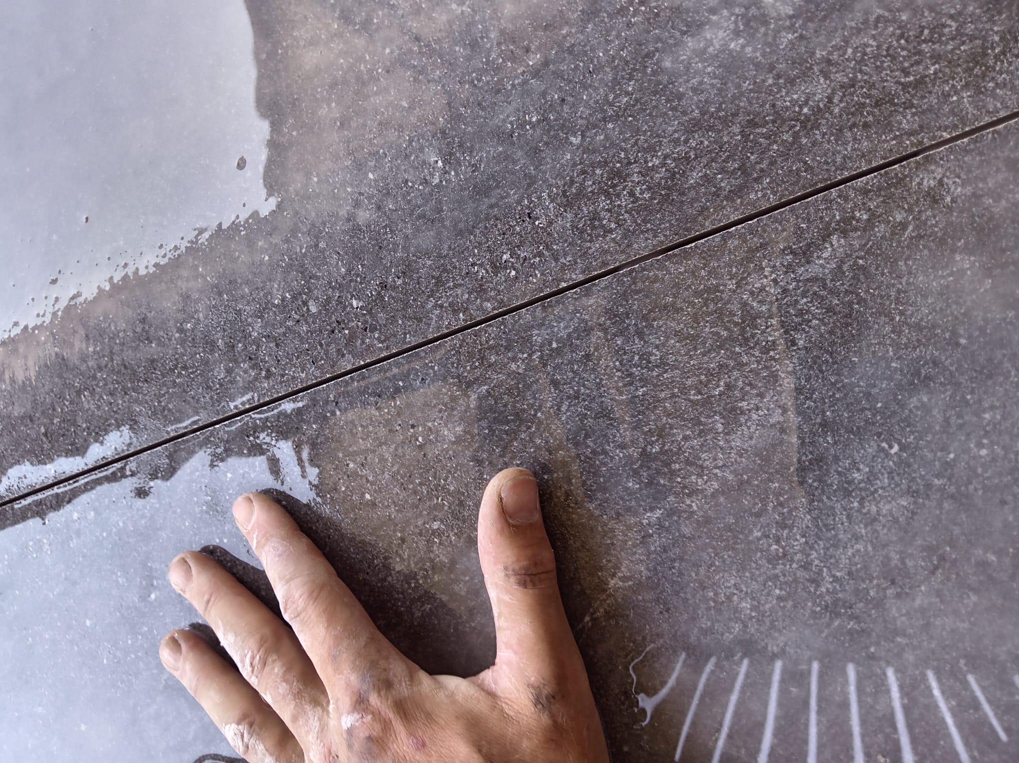 Close-up of a precision mitred joint on dark grey tile