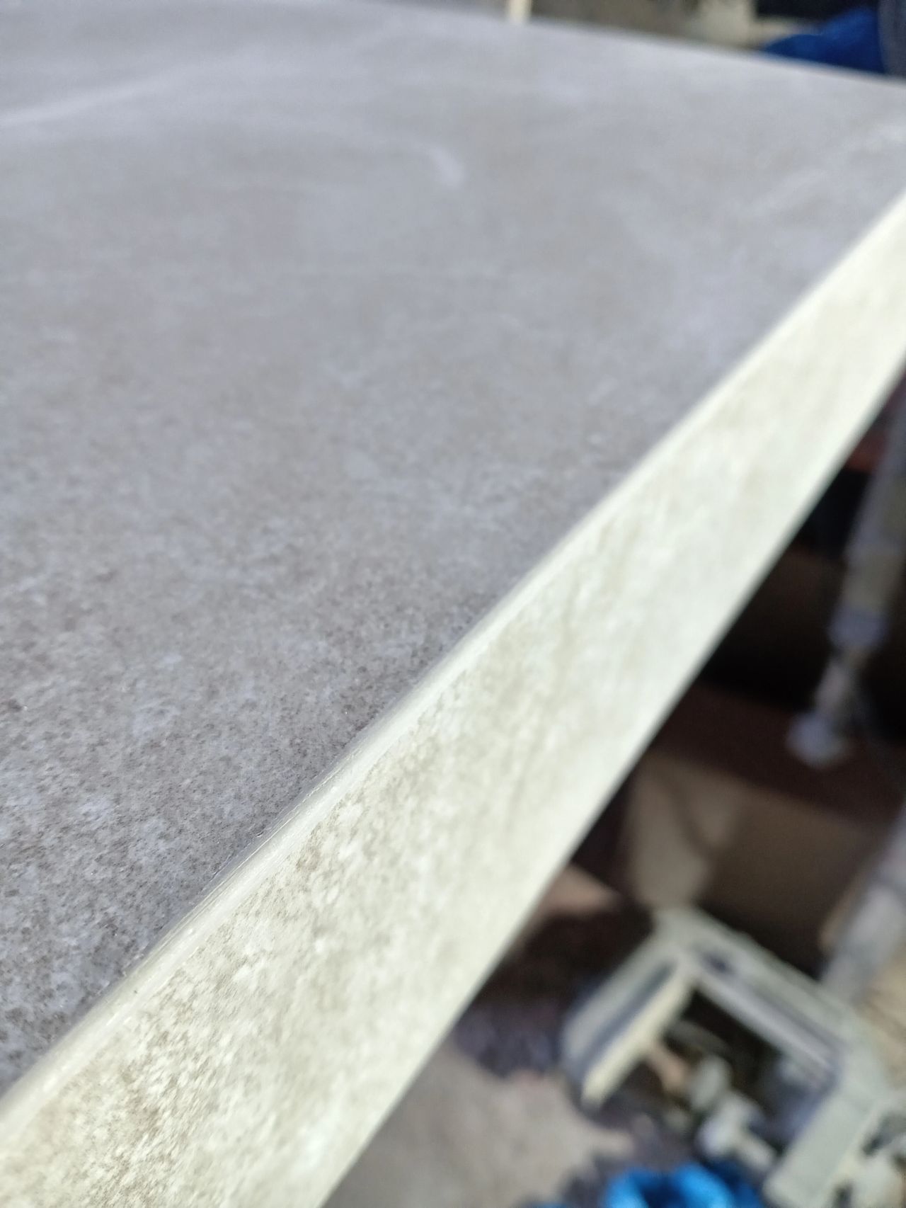 Close-up of a hand-finished full bullnose edge on a porcelain slab