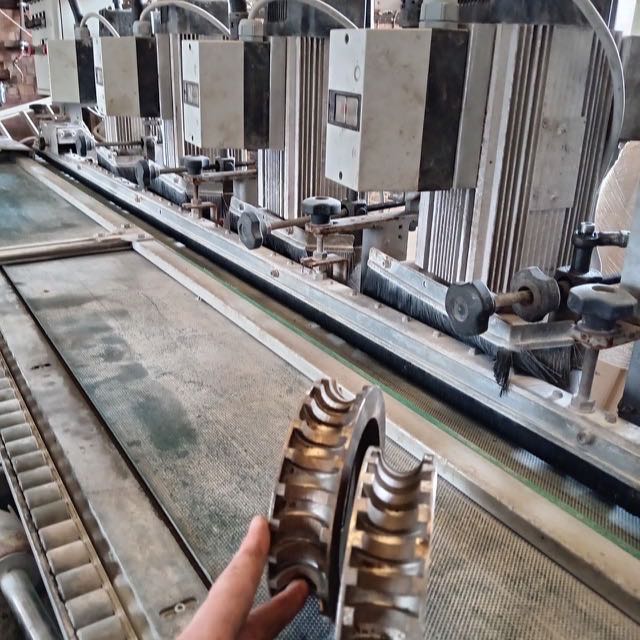 Close-up of the profiling wheel on the bullnose machine