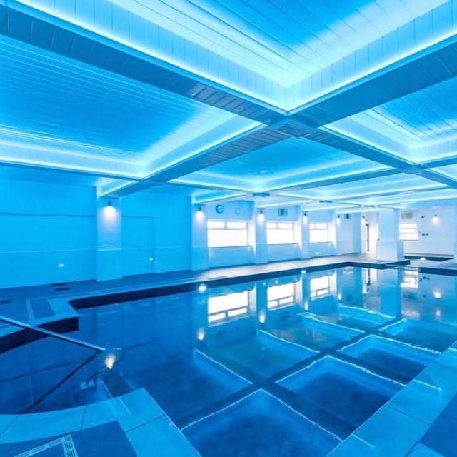 Indoor pool with a tiled surround and coping