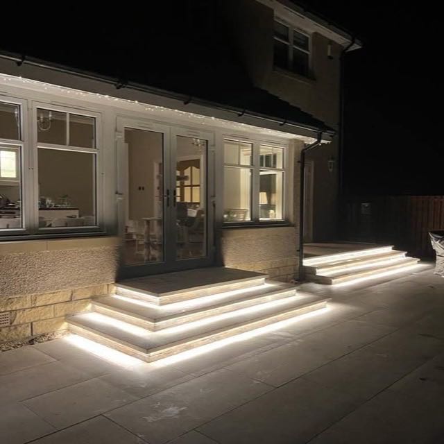 LED-lit natural stone garden steps at night