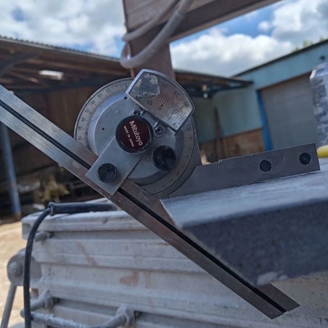 A protractor checking a mitre angle during fabrication