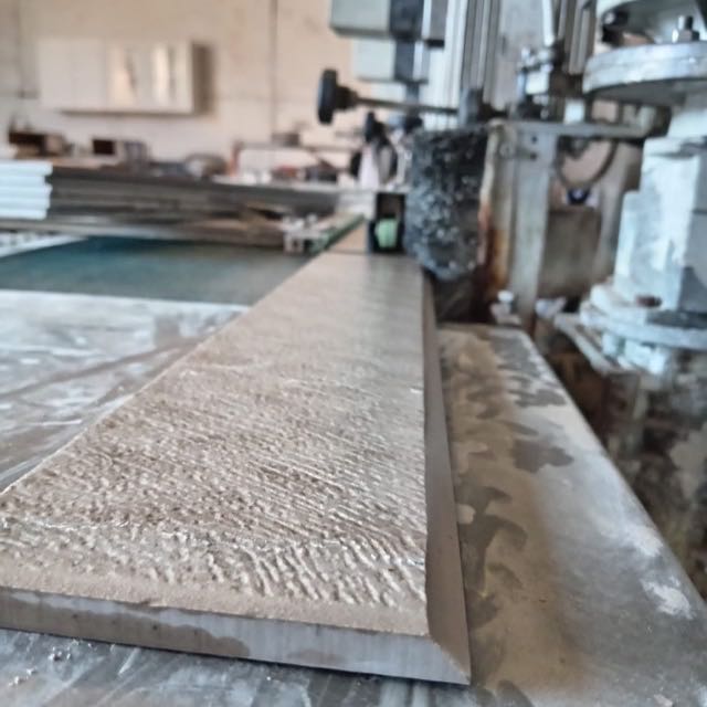 Textured porcelain tile with a mitred edge on the workshop bench
